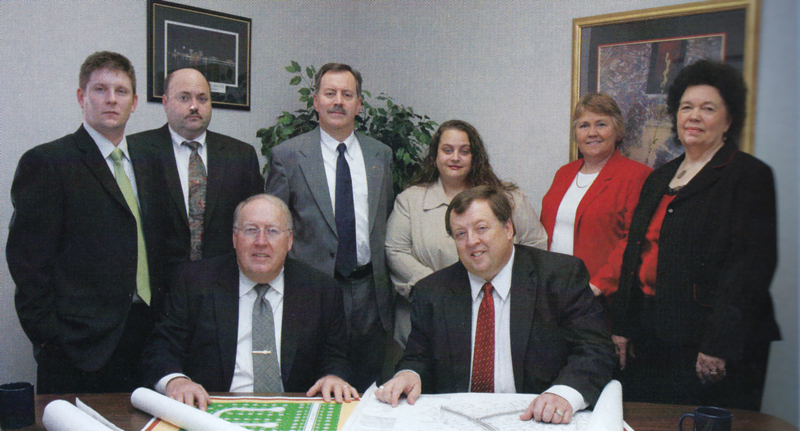 Back row: Chris Stuard, Kirk Mann, Randall Forster, Corine Kluemper, Anne Martin, and Shirley Fitzsimmons Front row: John Martin and Steve Martin, circa 2009. Photo provided by SVN | The Martin Group.